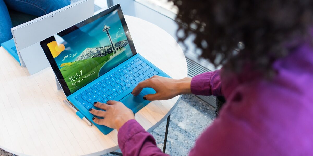 Persona usa laptop con tastiera blu